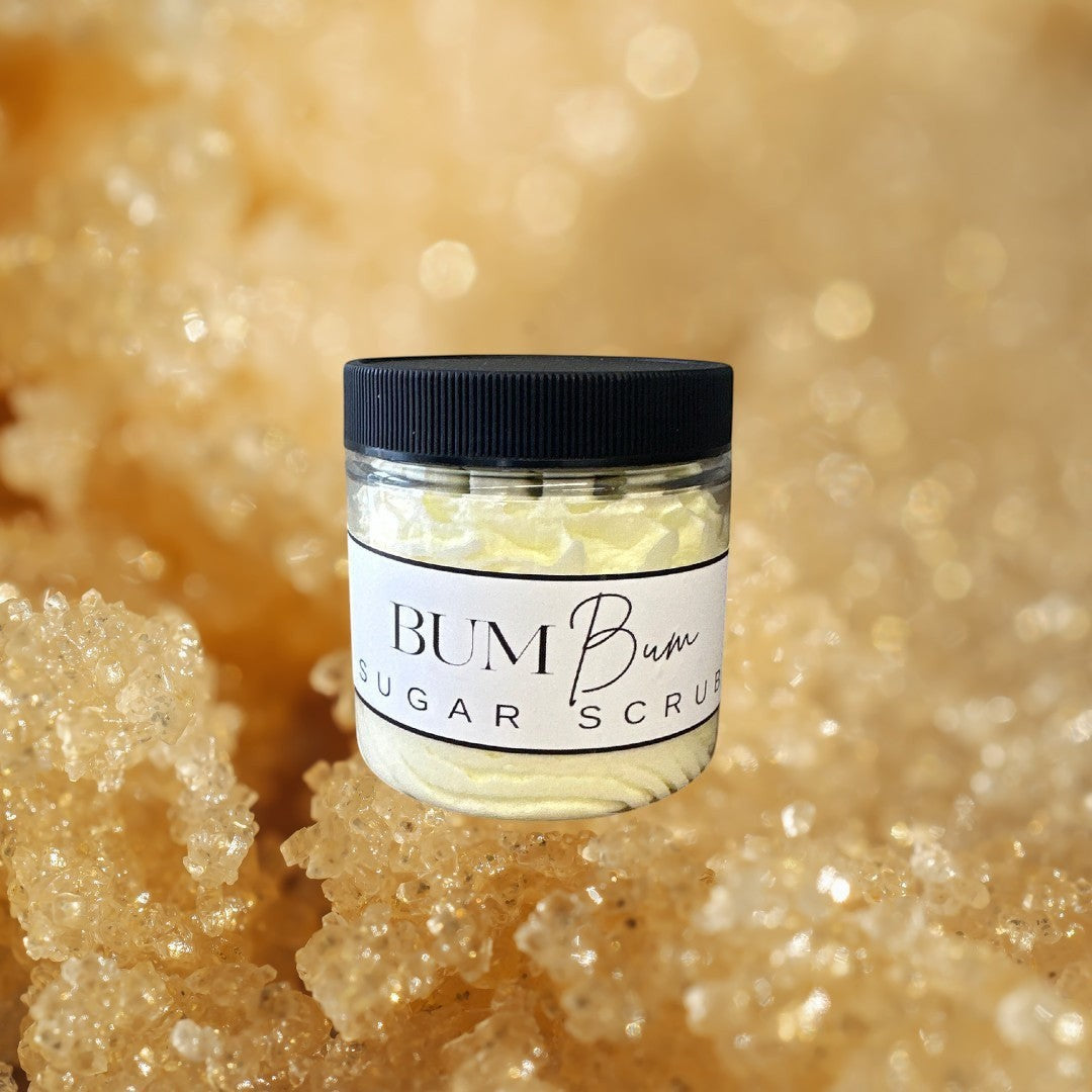 Doodlations Coffee Bar & Boutique Bum Bum Sugar Scrub in a clear jar with a black lid, light yellow creamy texture.