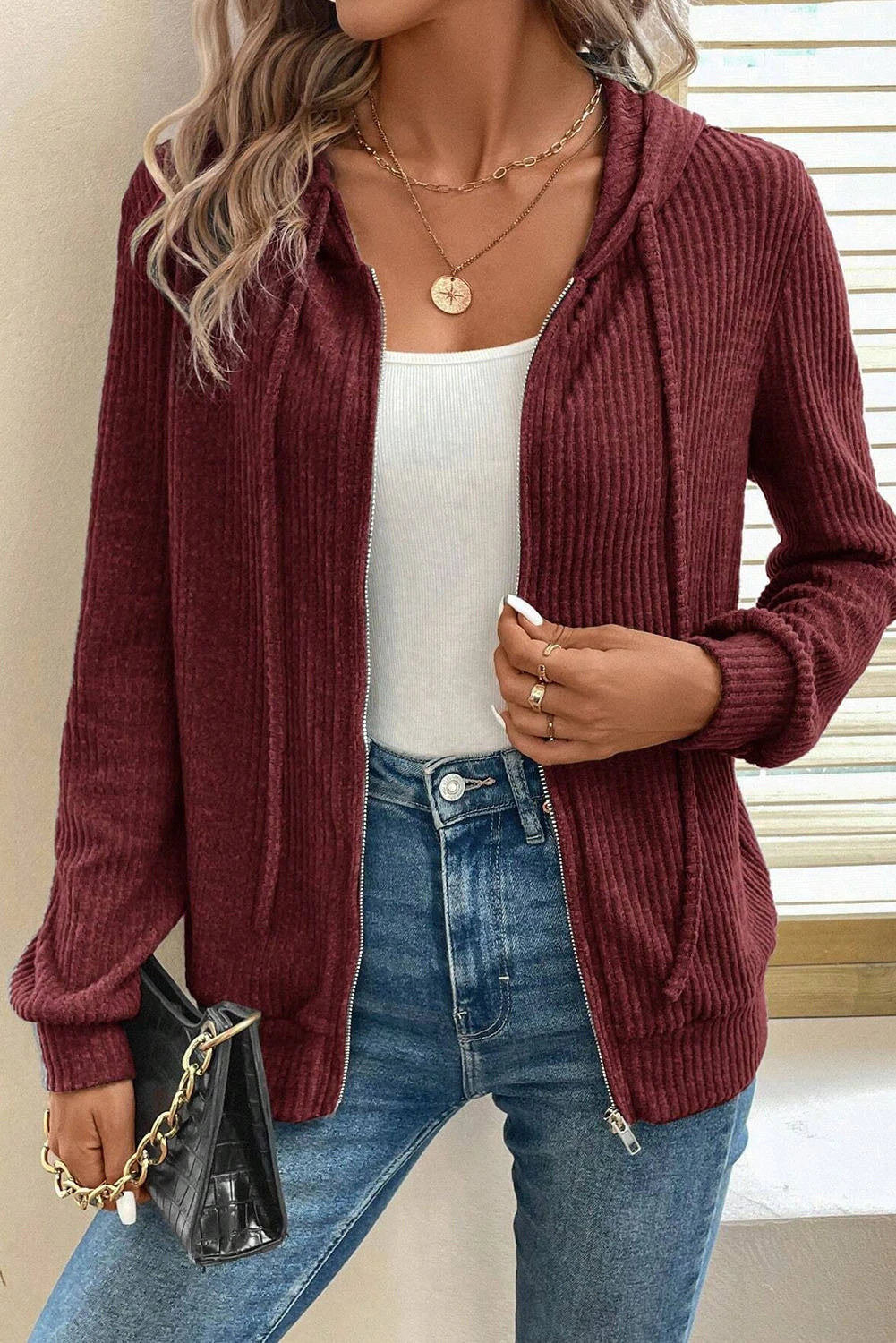 Doodlations Coffee Bar & Boutique burgundy ribbed zip-front hoodie with drawstring hood worn over a white tank top