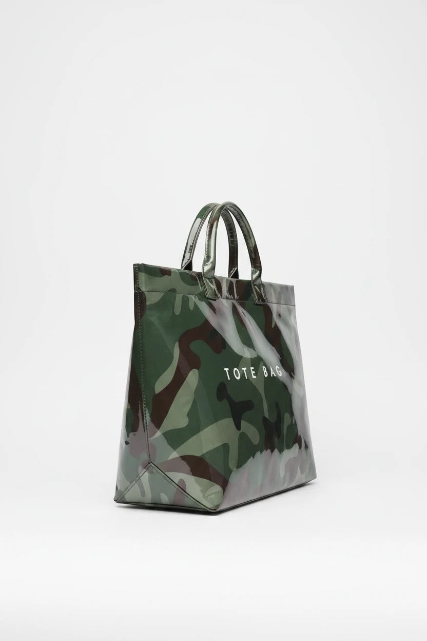 Doodlations Coffee Bar & Boutique camo tote bag with a glossy finish and white TOTE BAG text on a white background.