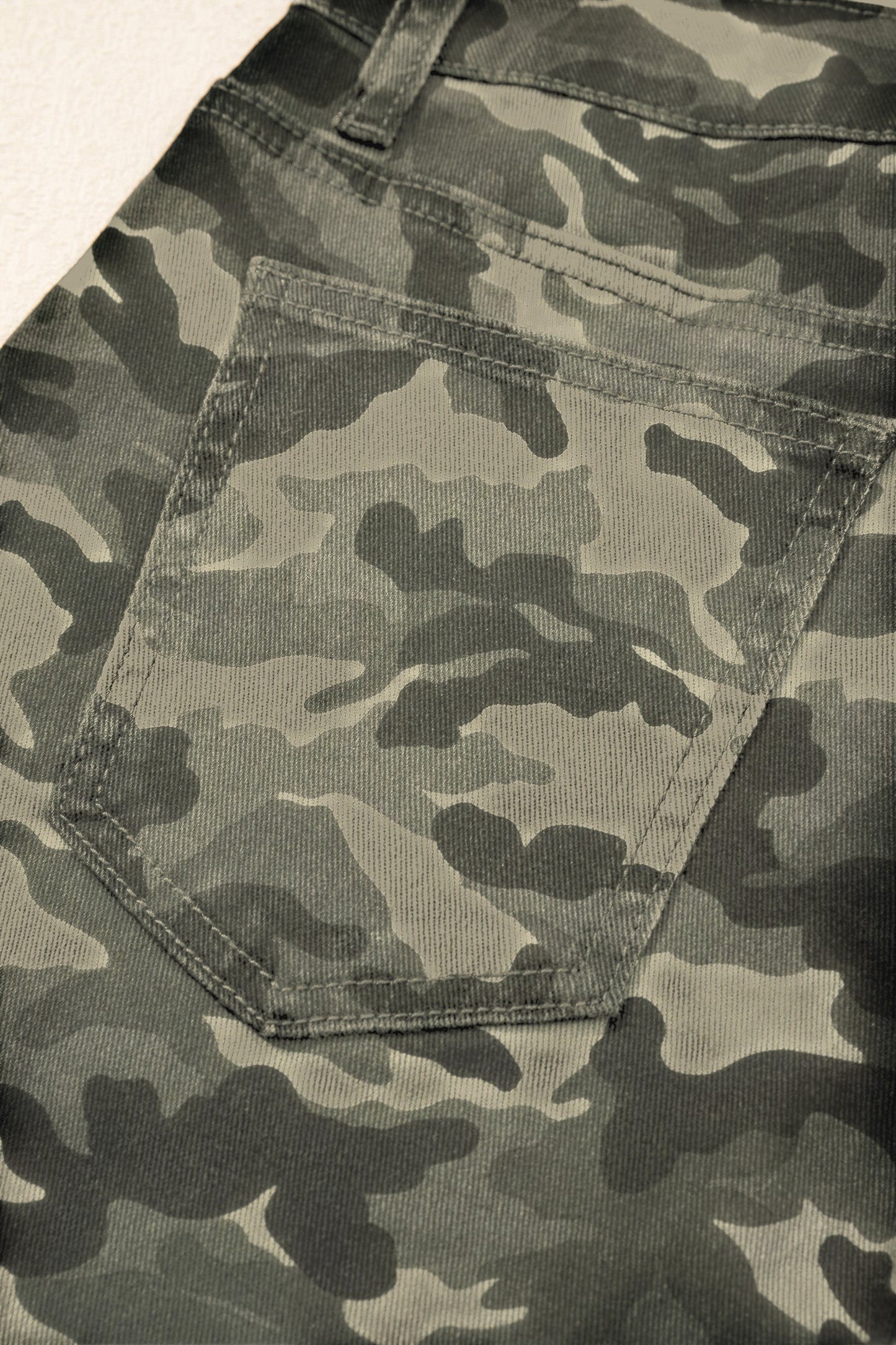 Doodlations Coffee Bar & Boutique women's camouflage cargo pants featuring a detailed back pocket and durable stitching.