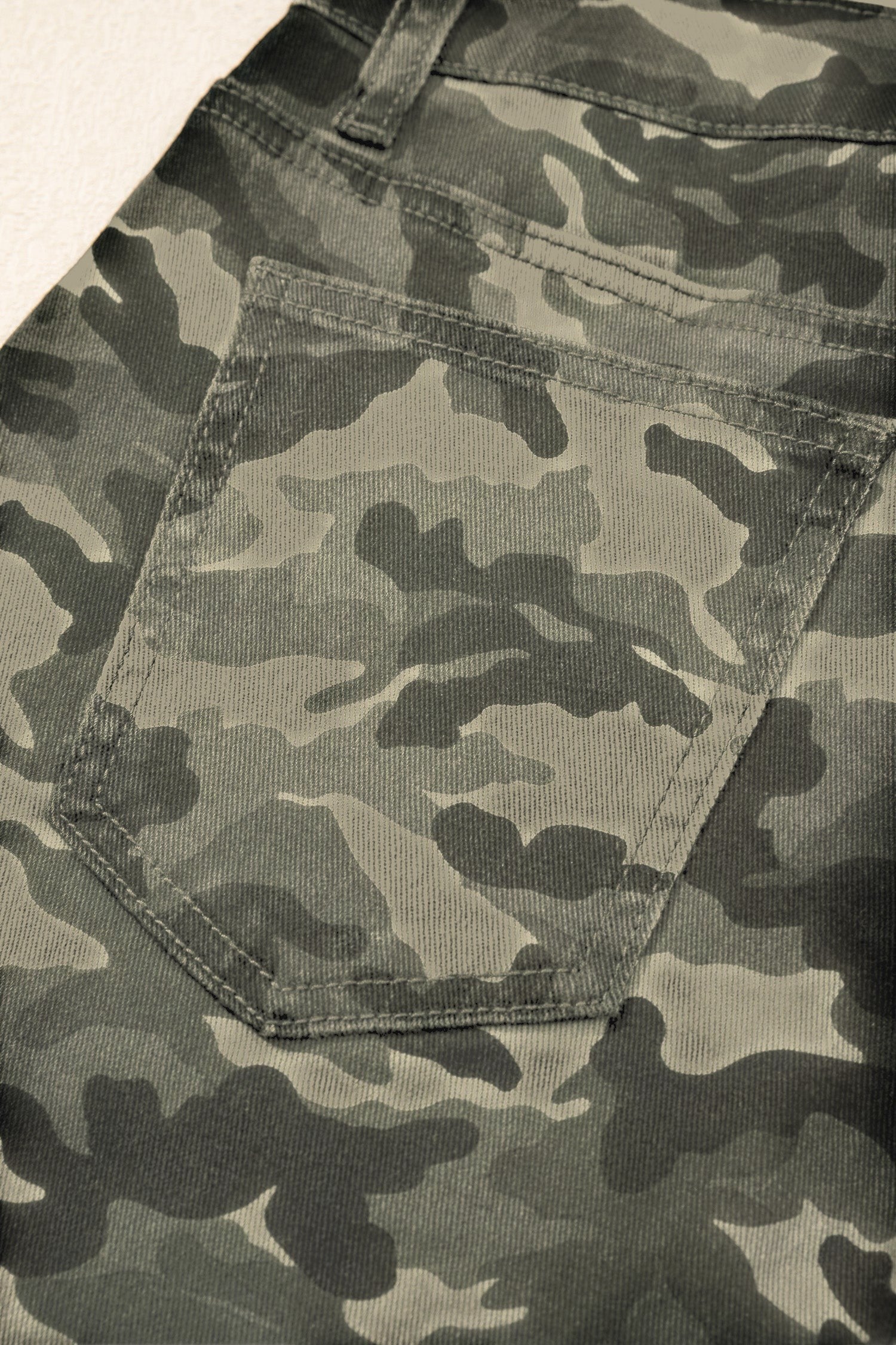 Doodlations Coffee Bar & Boutique women's camouflage cargo pants featuring a detailed back pocket and durable stitching.
