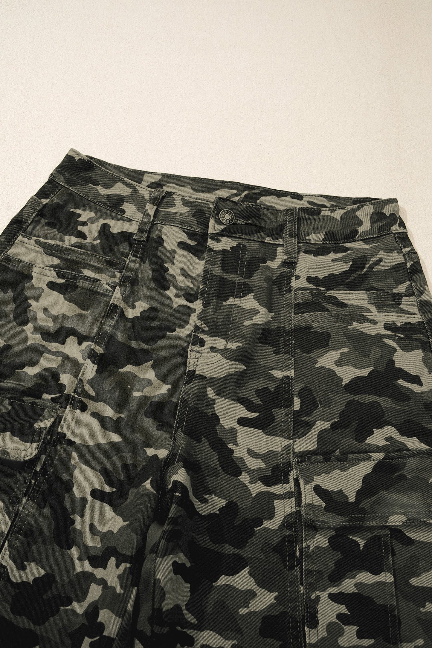 Doodlations Coffee Bar & Boutique women's camouflage utility cargo pants with multiple pockets and a button closure.