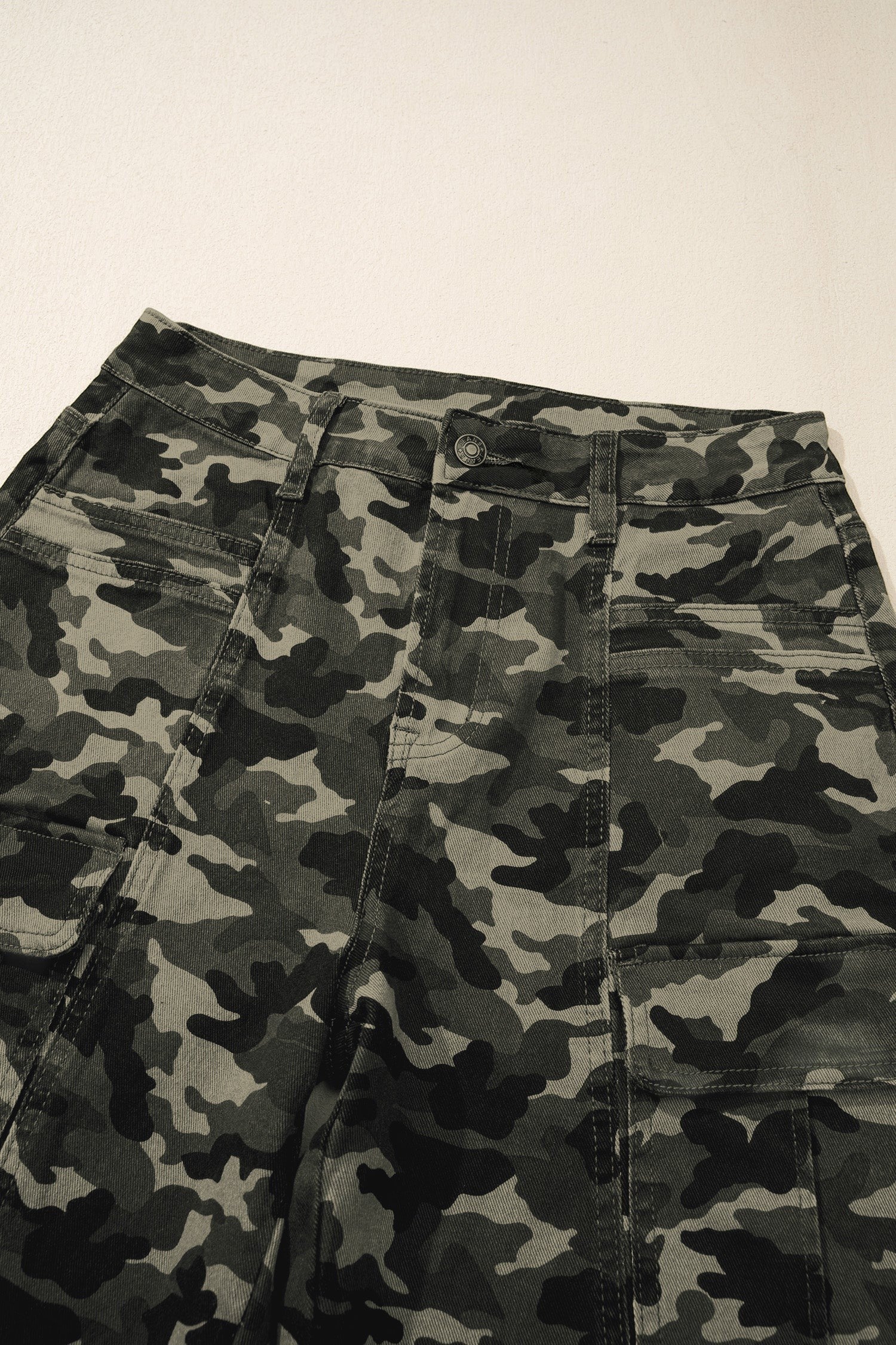 Doodlations Coffee Bar & Boutique women's camouflage utility cargo pants with multiple pockets and a button closure.