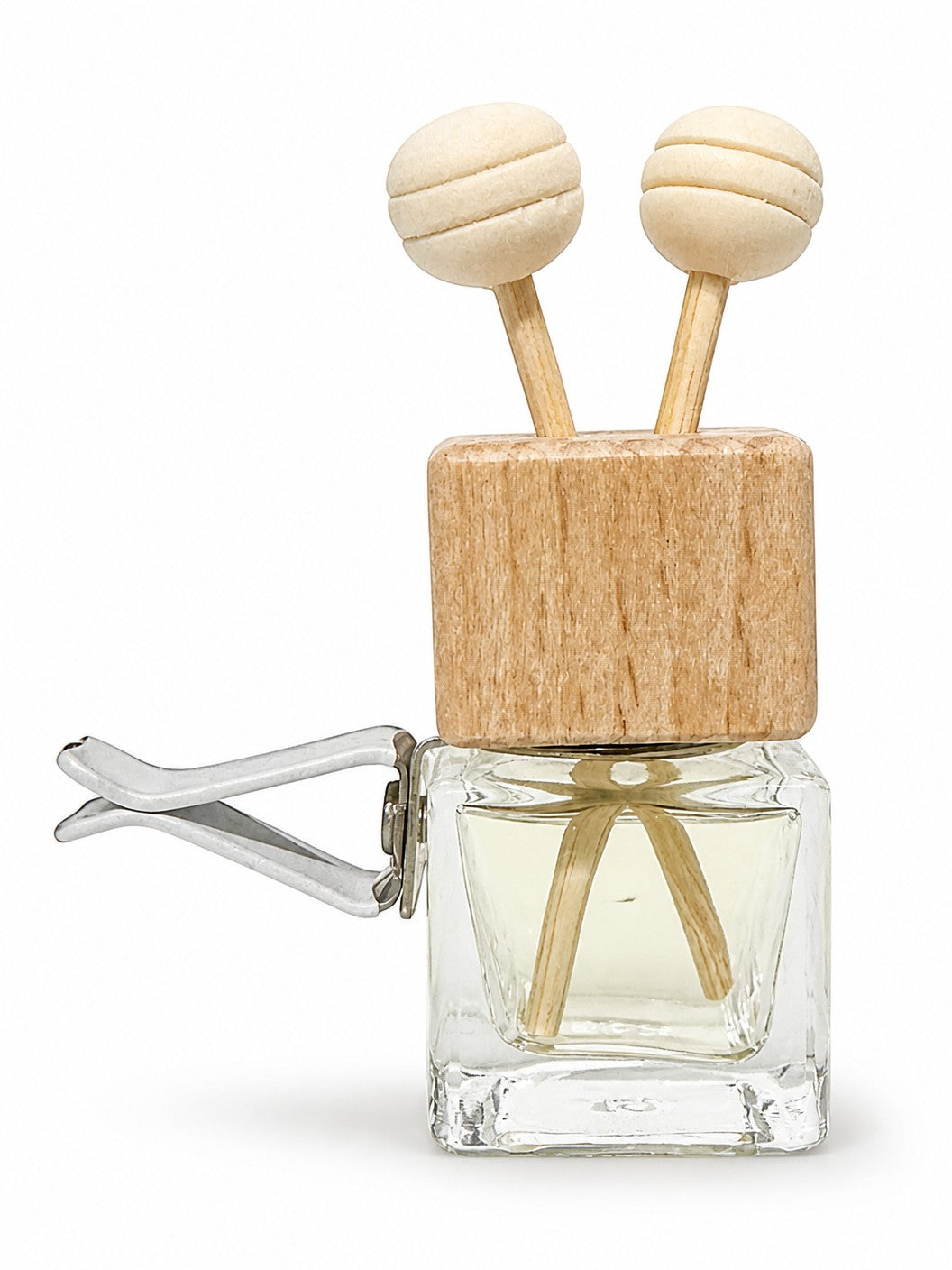 Doodlations Coffee Bar & Boutique car air freshener with a glass bottle, wooden lid, and two decorative sticks.