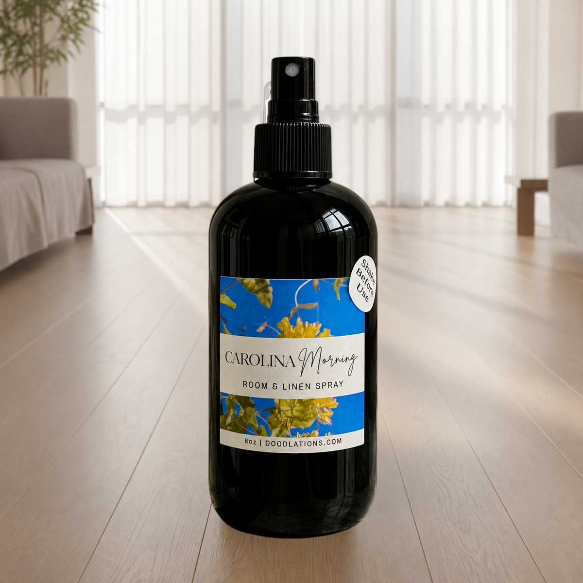 Doodlations Coffee Bar & Boutique Carolina Morning room and linen spray in a black bottle with a floral label.
