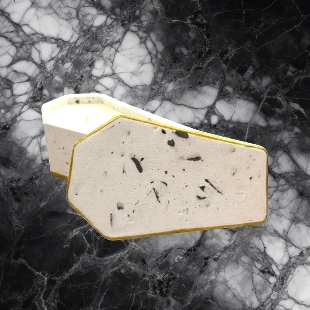 Doodlations Coffee Bar & Boutique casket concrete candle with two wicks and gold trim. Modern home accent.