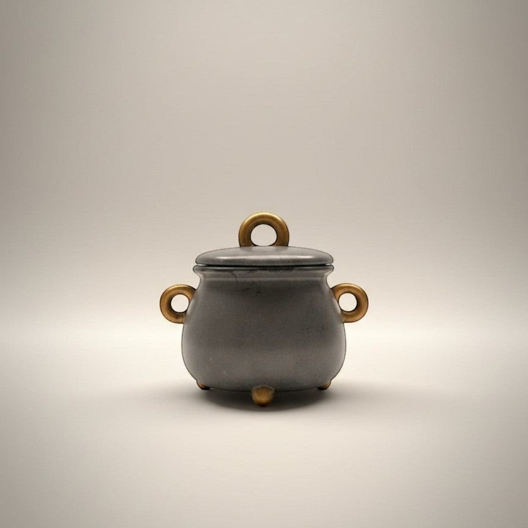 Doodlations Coffee Bar & Boutique cauldron concrete candle with wooden handles and gold feet. 8oz soy blend candle in a modern concrete vessel.