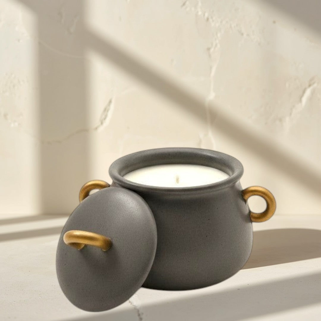 Doodlations Coffee Bar & Boutique cauldron concrete candle with gold handle on lid and sides, filled with soy wax.