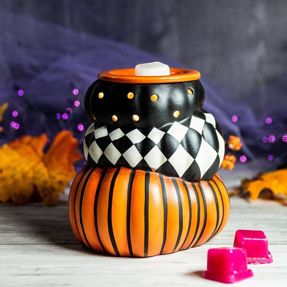 Doodlations Coffee Bar & Boutique ceramic pumpkin wax warmer with black, orange, and harlequin patterns for fall decor