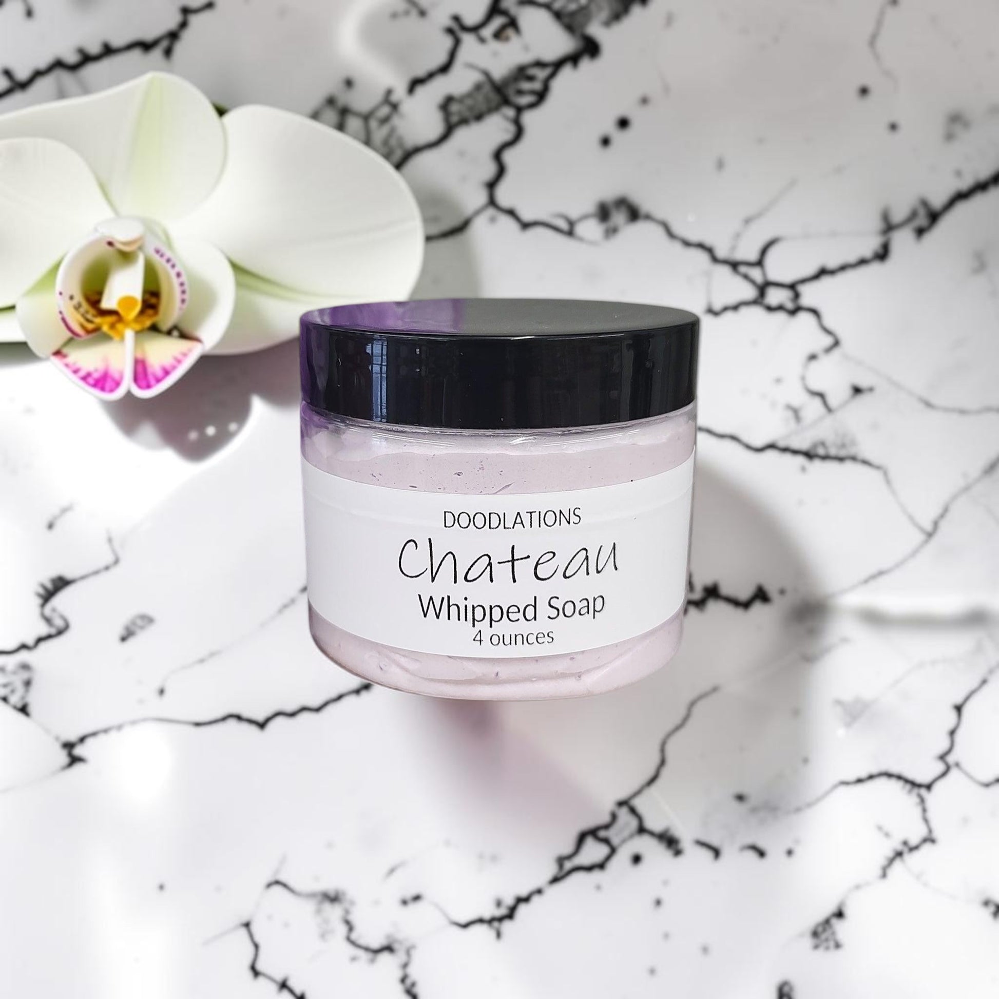Doodlations Coffee Bar & Boutique Chateau whipped soap in a 4oz jar with a grape scent and purple bath loofah
