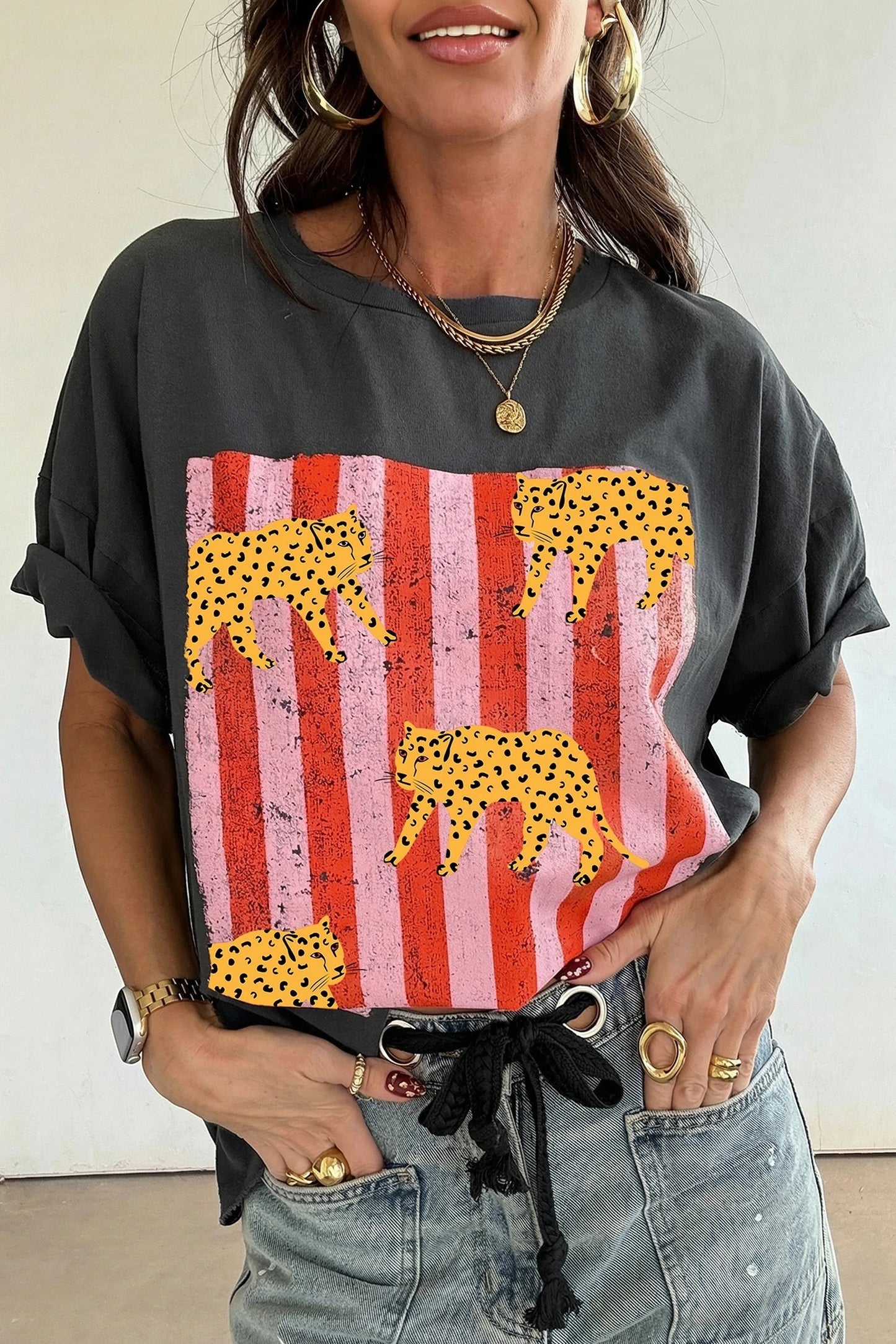 Doodlations Coffee Bar & Boutique dark grey retro graphic tee with cheetah and pink striped print on a woman
