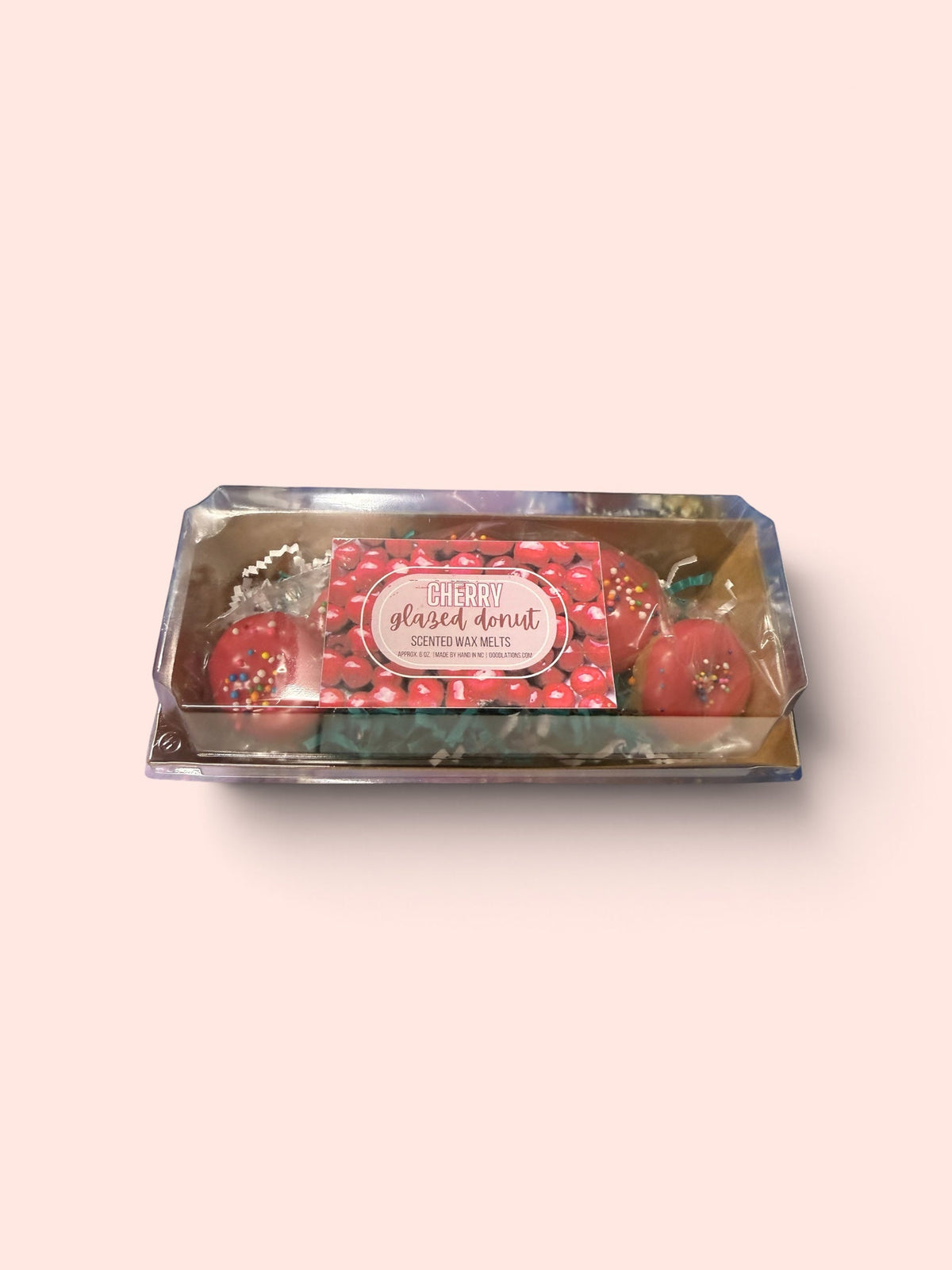 Doodlations Coffee Bar & Boutique cherry glazed doughnut wax melts in a clear box with colorful sprinkles