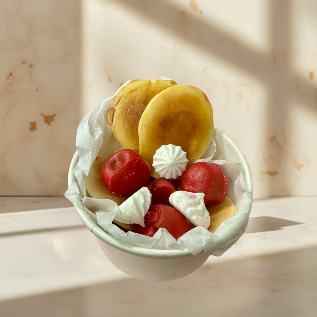 Doodlations Cherry Pancake wax melts shaped like pancakes, cherries, and meringues in a pink bowl.