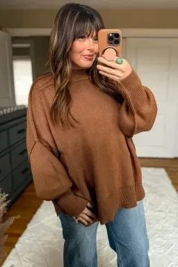 Doodlations Coffee Bar & Boutique chestnut oversized ribbed knit sweater with long sleeves on a woman taking a selfie.
