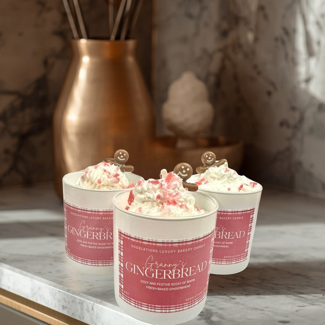 Doodlations Coffee Bar & Boutique Christmas Gingerbread luxury bakery candle with whipped cream and gingerbread man topper.