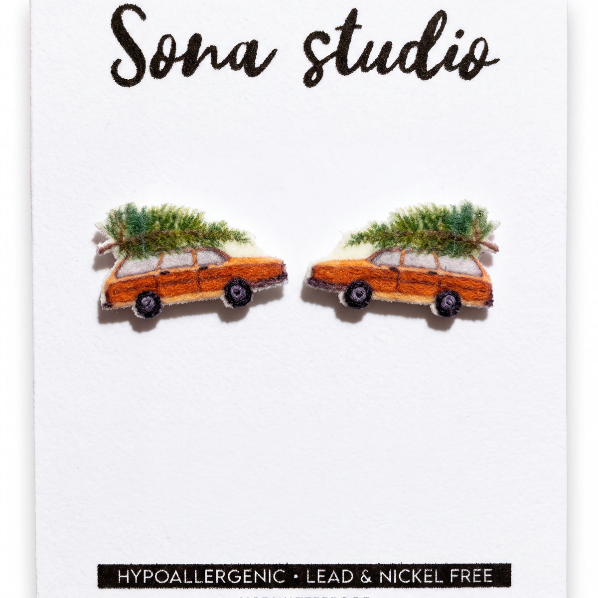 Doodlations Coffee Bar & Boutique handmade Christmas wagon earrings featuring orange cars with pine trees on top