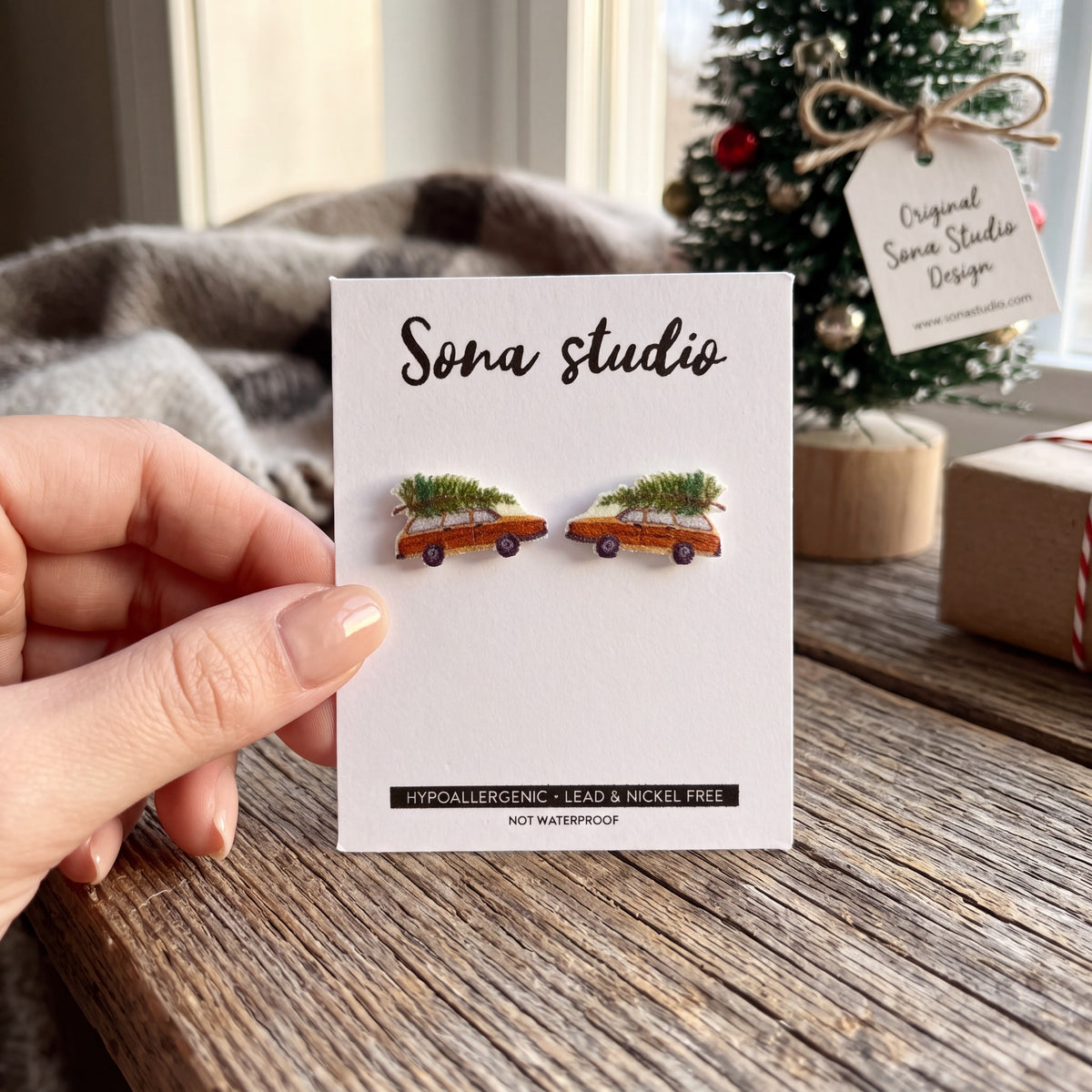 Doodlations Coffee Bar & Boutique Christmas wagon earrings featuring a vintage car with a tree on a display card.