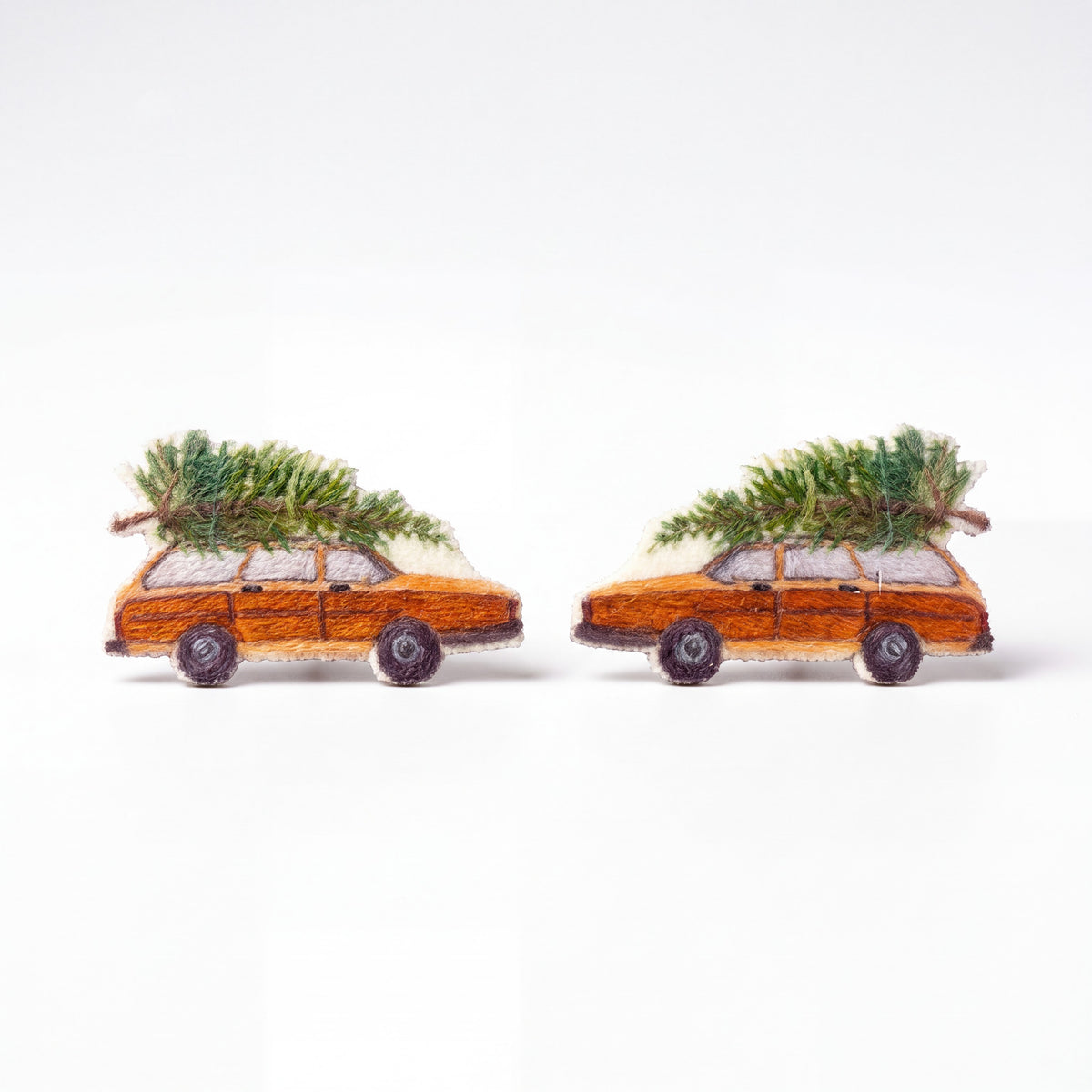 Doodlations Coffee Bar & Boutique handmade Christmas wagon earrings featuring orange station wagons with pine trees.