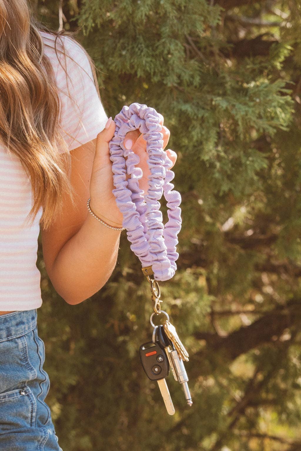Doodlations Coffee Bar & Boutique chunky purple textured fabric wristlet lanyard holding keys outdoors