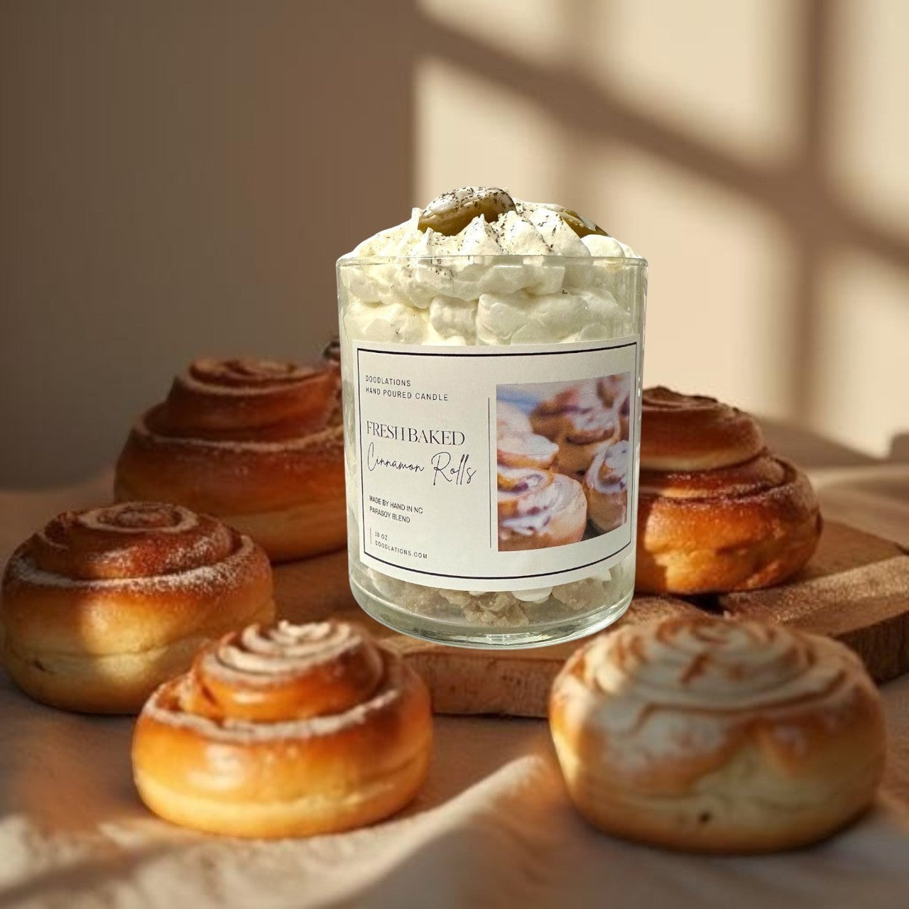 Doodlations Coffee Bar & Boutique Cinnamon Bun candle with decorative wax toppings resembling cinnamon rolls and whipped cream.