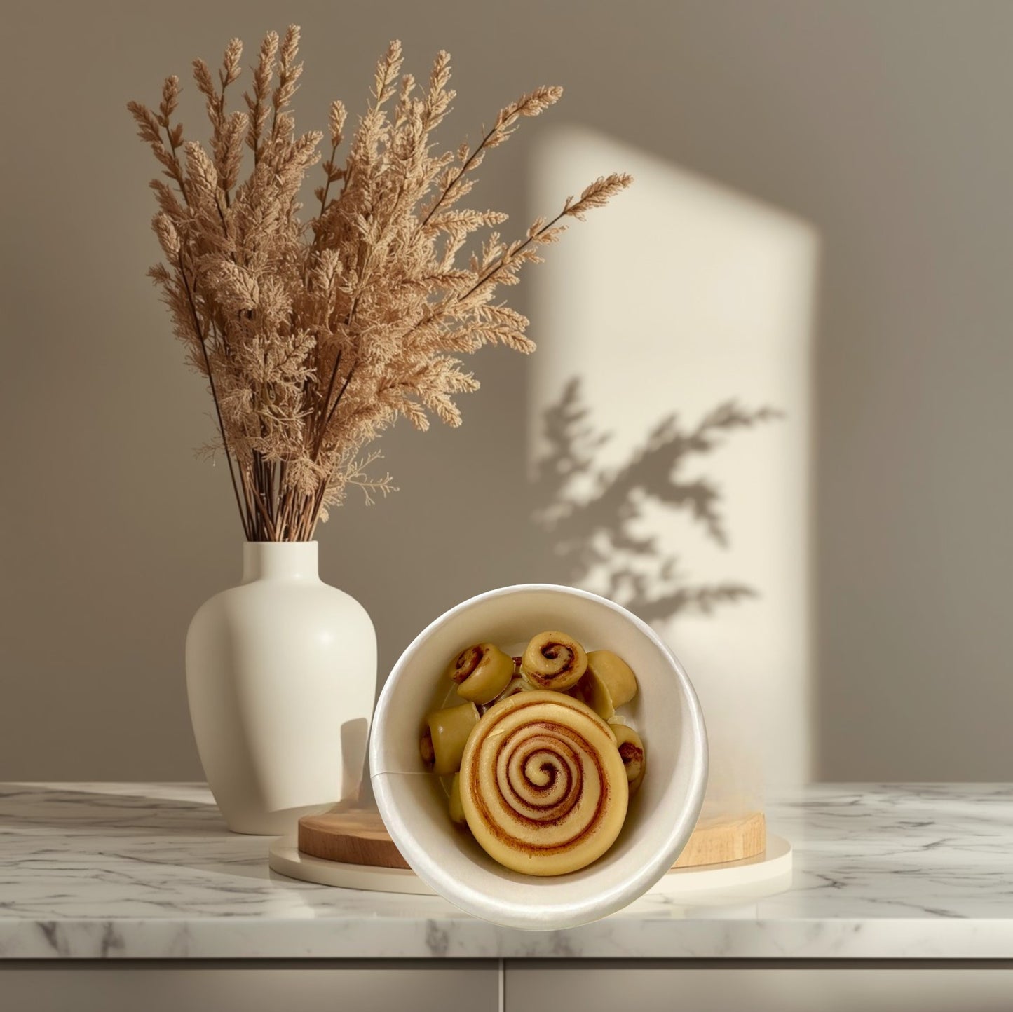 Doodlations Coffee Bar & Boutique Cinnamon Roll wax melts in a bowl, resembling freshly baked cinnamon rolls.