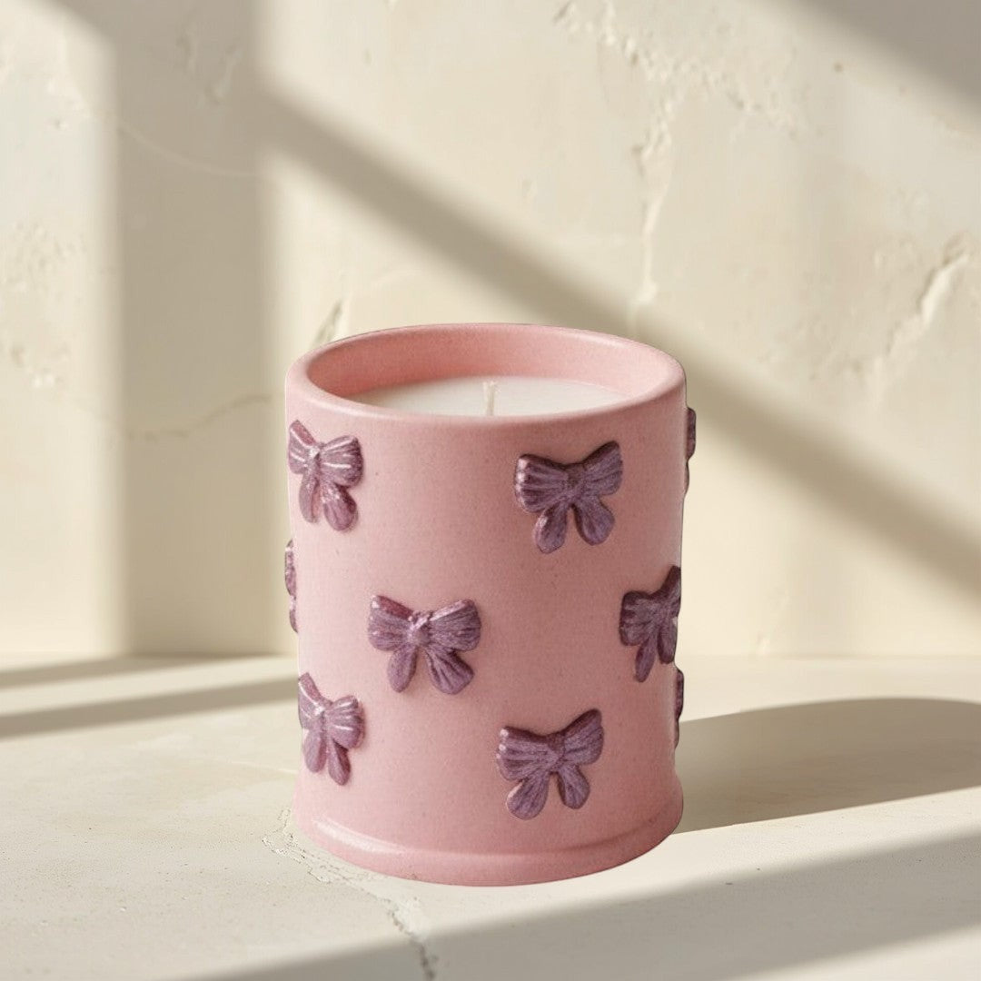 Doodlations Coffee Bar & Boutique pink concrete candle with bow details, soy blend wax, Tipsy Berry Cherry scent.