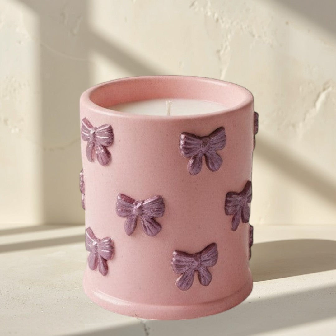 Doodlations Coffee Bar & Boutique pink concrete candle with bow details, soy blend wax, Tipsy Berry Cherry scent.