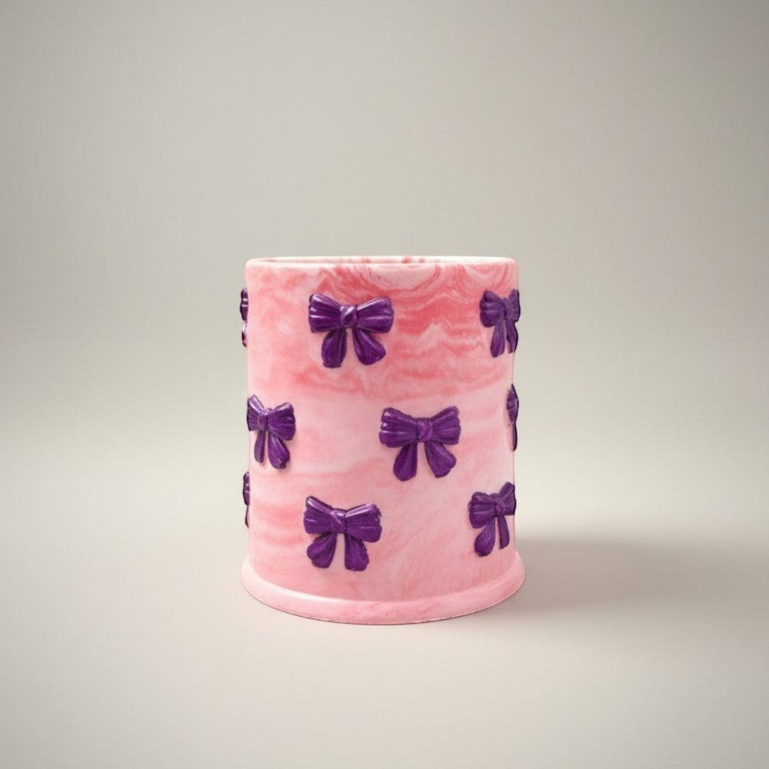 Doodlations Coffee Bar & Boutique pink marbled concrete candle with purple bow accents, 8oz soy blend wax