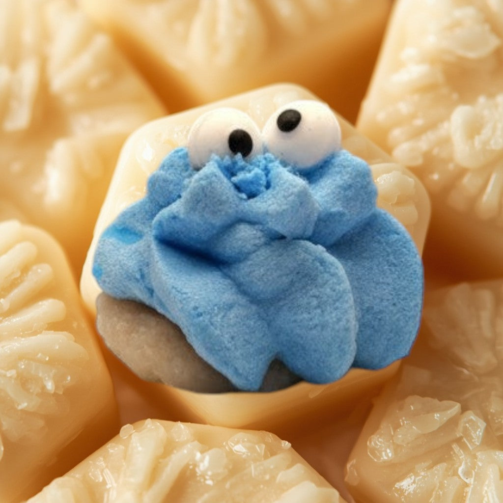 Doodlations Coffee Bar & Boutique blue Cookie Monster wax melt with googly eyes on a light brown cookie base.