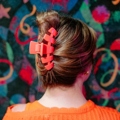 Doodlations Coffee Bar & Boutique coral segmented claw hair clip holding updo.