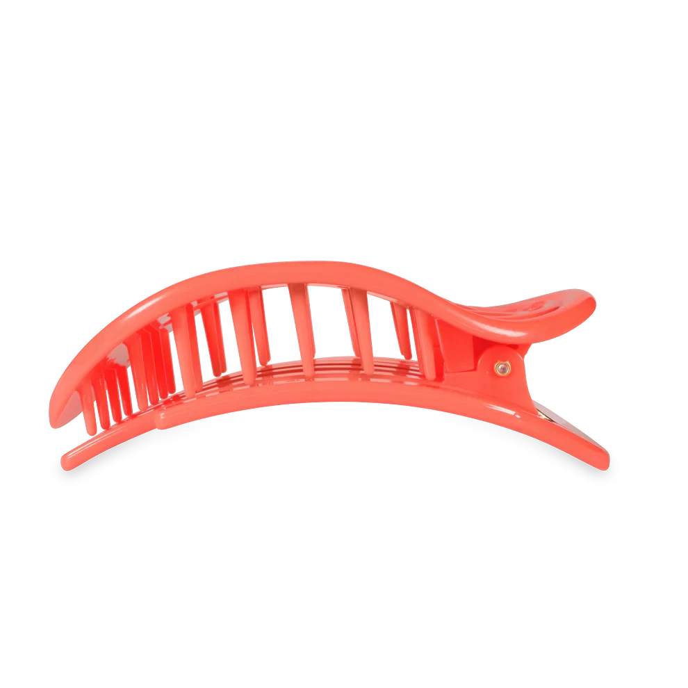 Doodlations Coffee Bar & Boutique coral flat round hair clip with ribbed texture and flexible material for a secure hold.