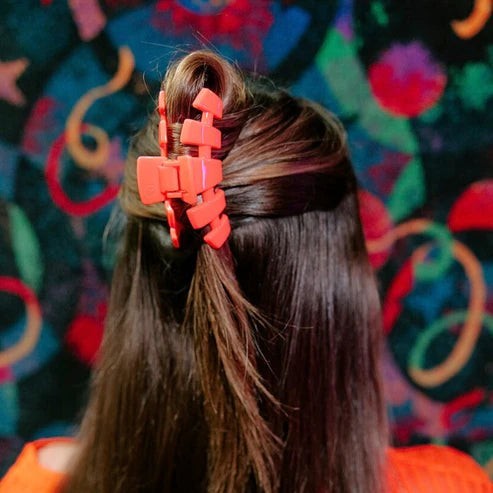Doodlations Coffee Bar & Boutique coral segmented hair claw clip for updos and half-up styles.