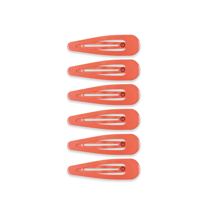 Set of six coral-coloured TELETIES Snap Clip hair clips with a smooth, snag-free finish on a black background.