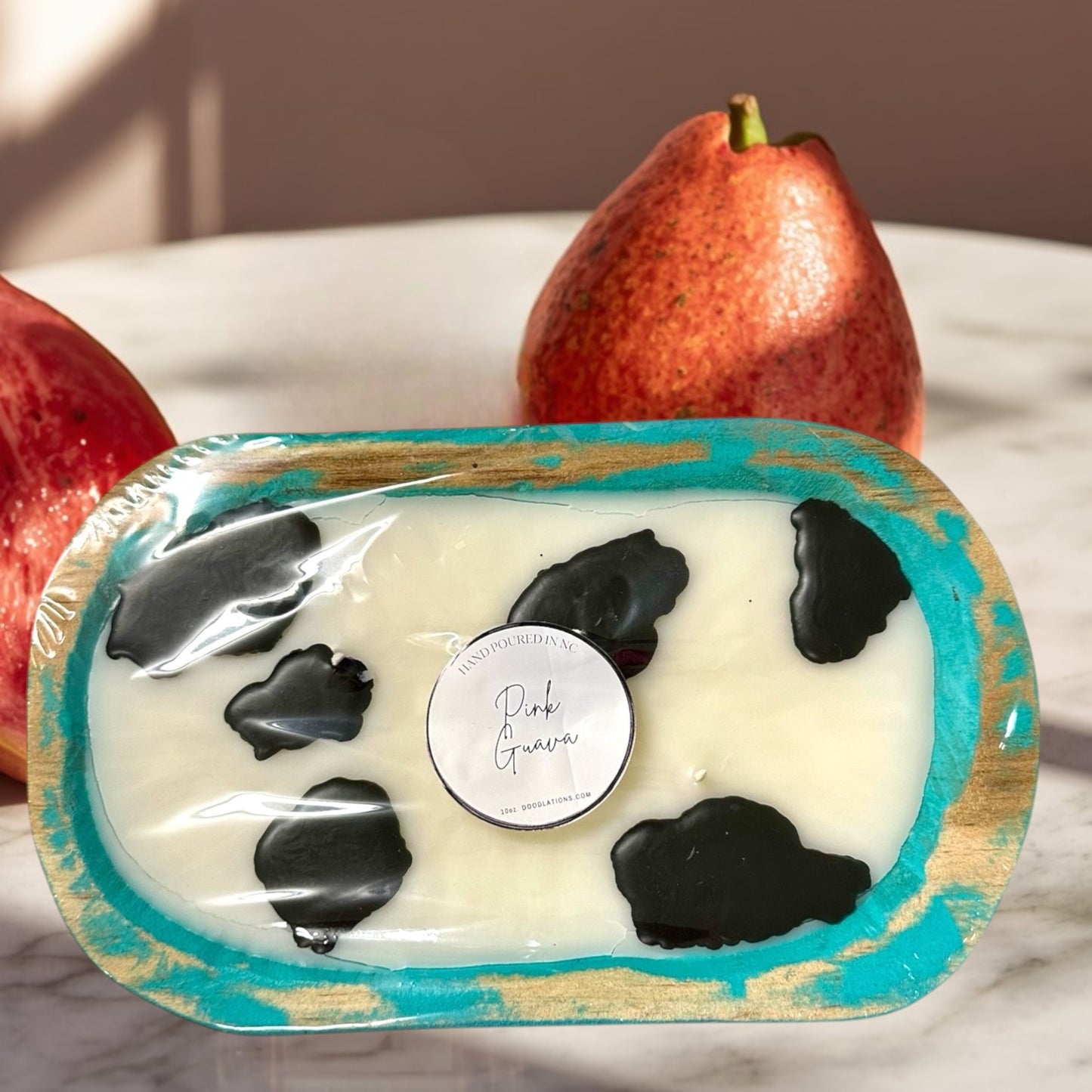 Doodlations Coffee Bar & Boutique Cow Dough Bowl Candle in Pink Guava scent, hand-poured wax with black cow spots.