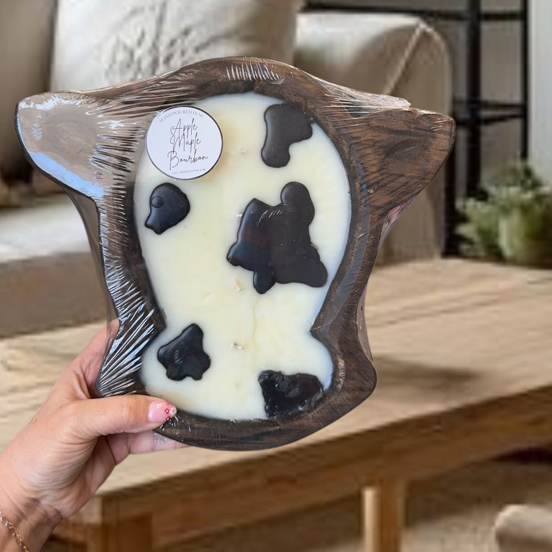 Doodlations Coffee Bar & Boutique Apple Maple Bourbon large cow head dough bowl candle with black cow spots.