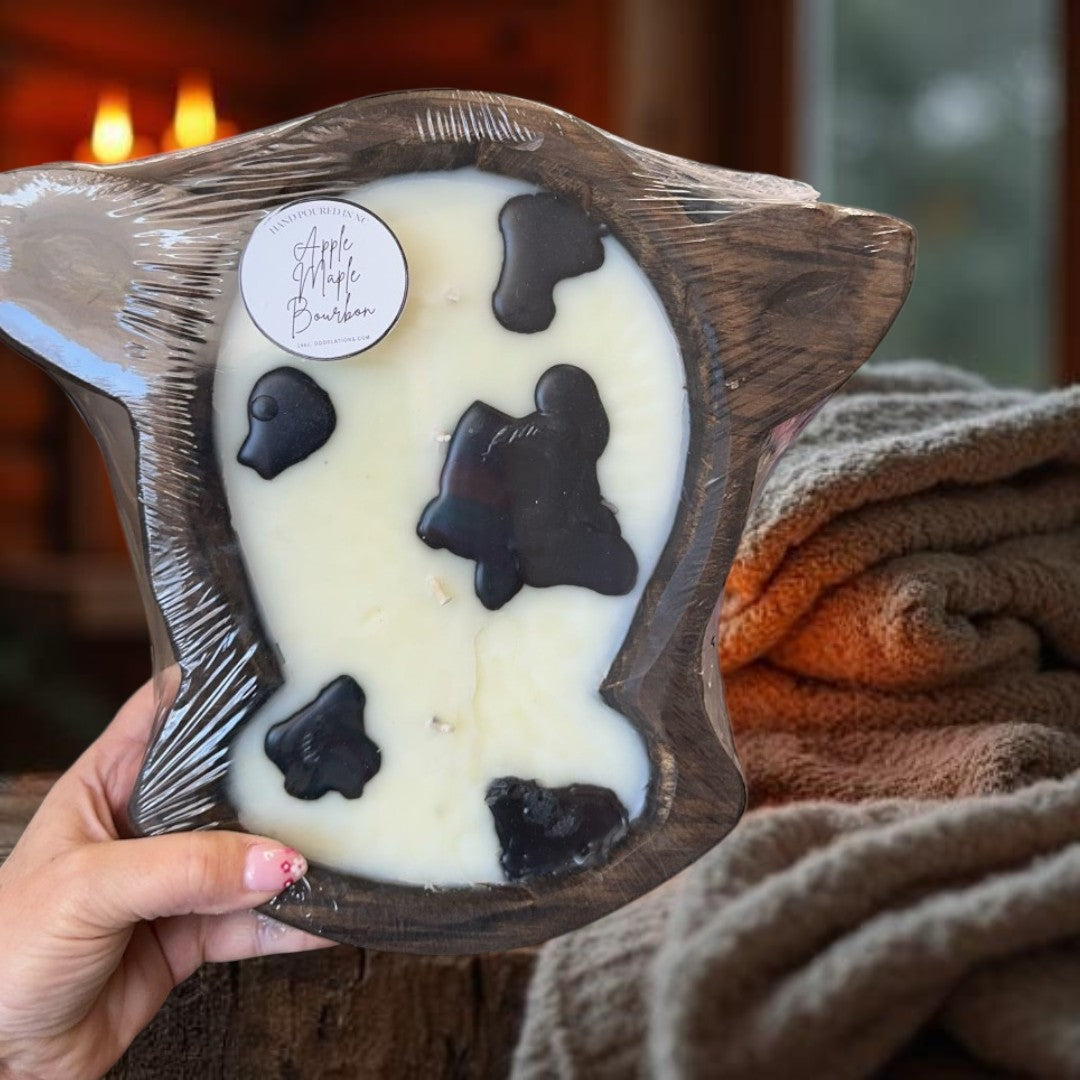 Doodlations Coffee Bar & Boutique Apple Maple Bourbon large cow head dough bowl candle with black spots. Rustic farmhouse decor.