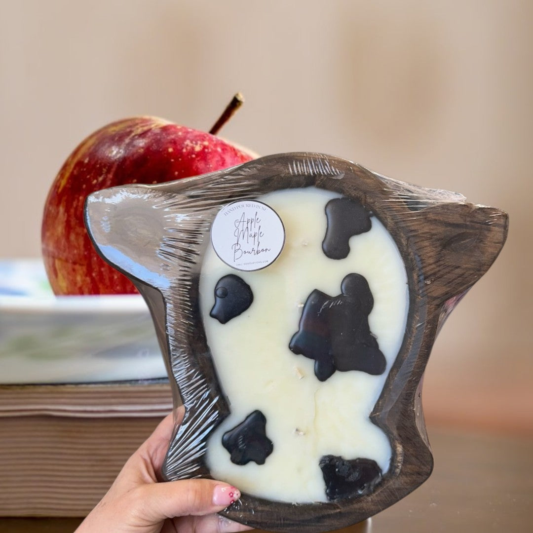 Doodlations Coffee Bar & Boutique Apple Maple Bourbon large cow head dough bowl candle with black cow spots.
