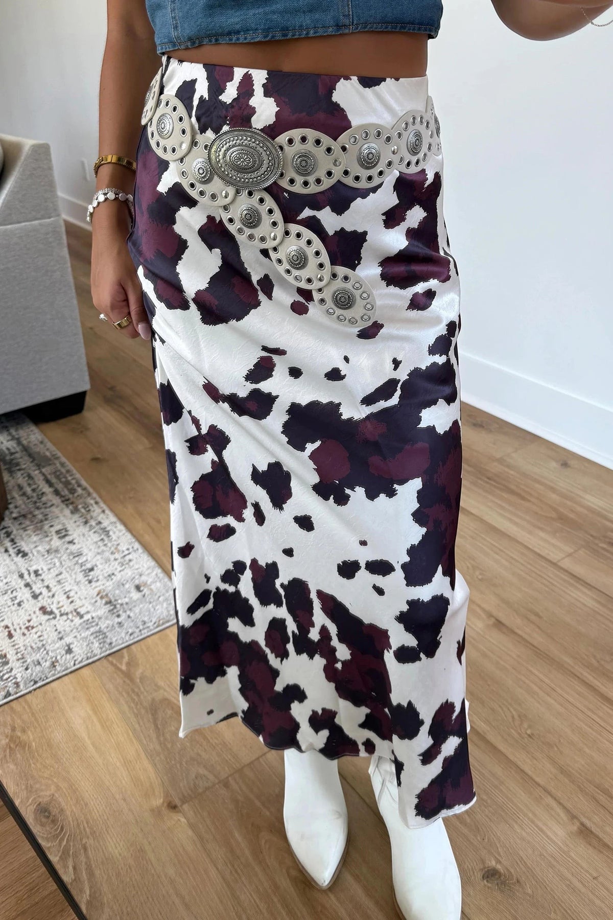 Doodlations Coffee Bar & Boutique brown and white cow print midi skirt with a decorative silver concho waist belt