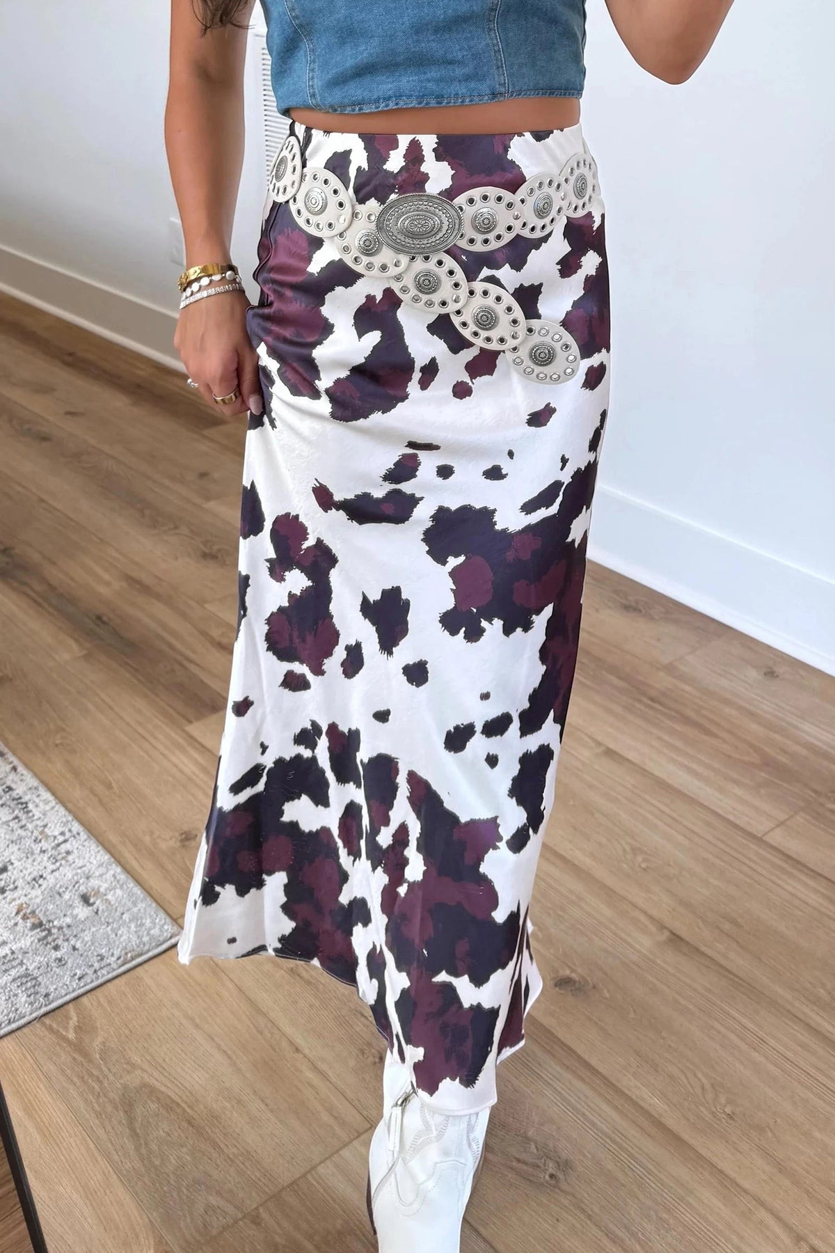 Doodlations Coffee Bar & Boutique brown and white cow print midi skirt with a silver western concho belt