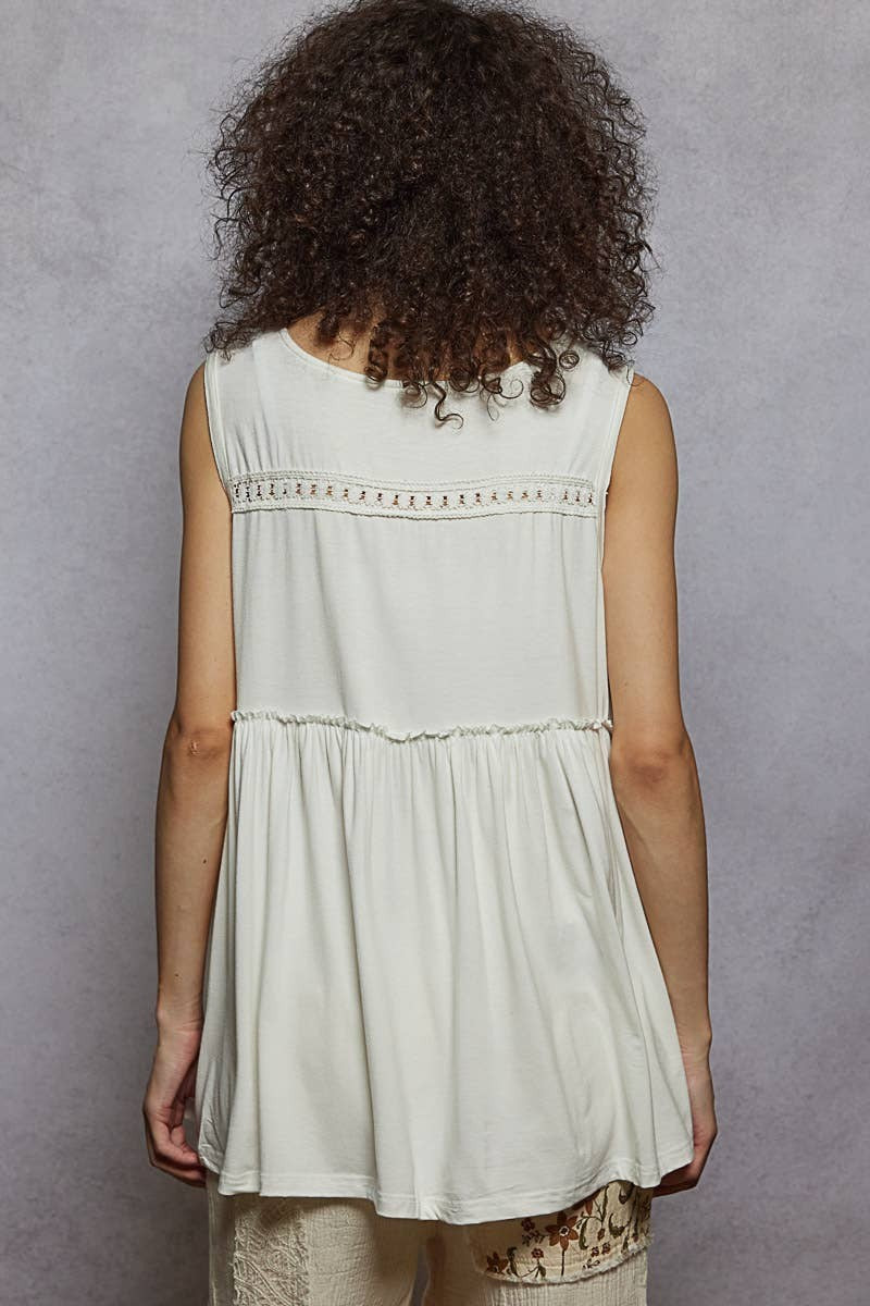 Doodlations Coffee Bar & Boutique sleeveless cream babydoll top with lace trim and ruffle detail on back yoke