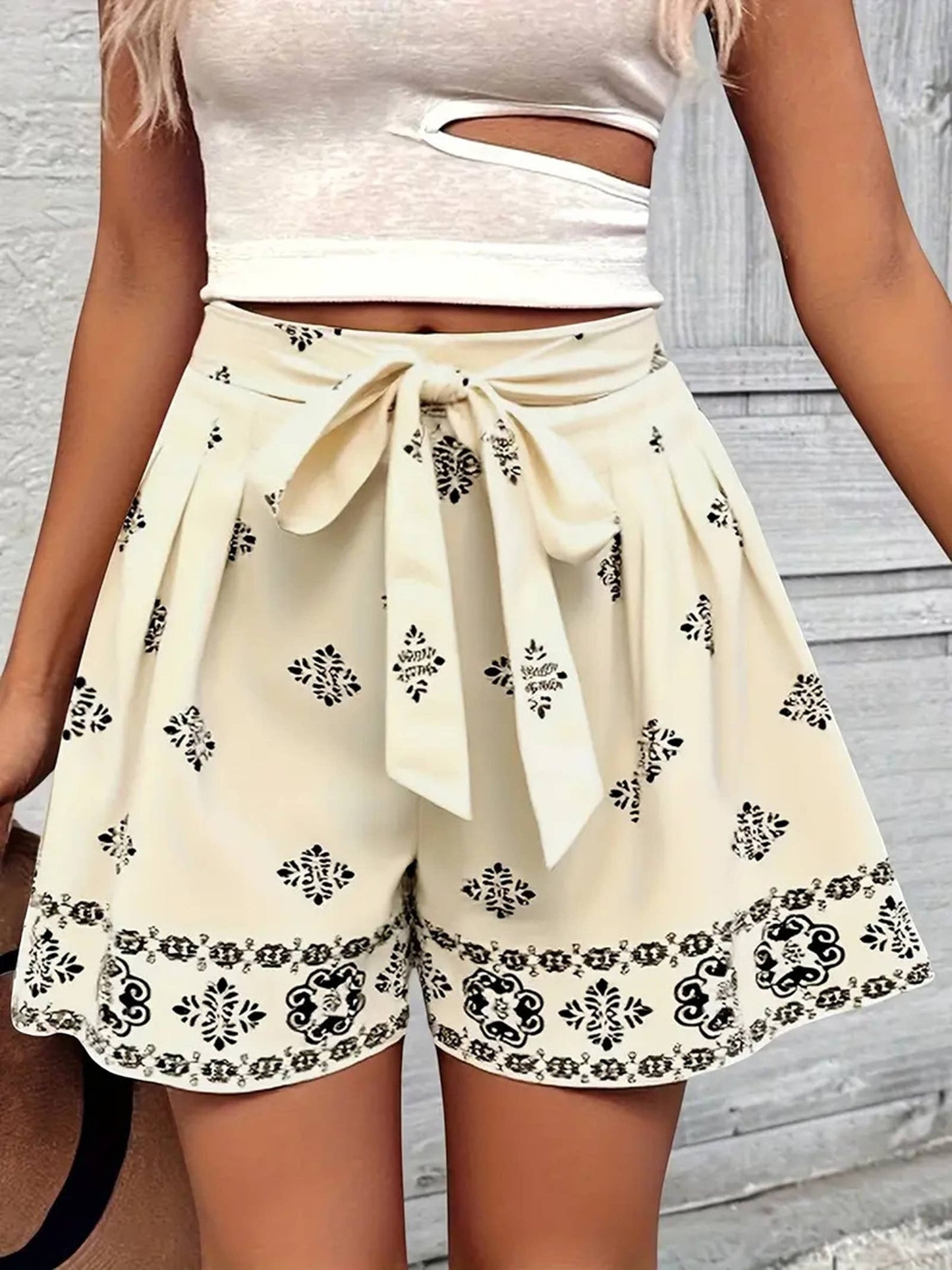 Doodlations Coffee Bar & Boutique cream shorts with black print, high-waisted with tie belt and pleated detail.