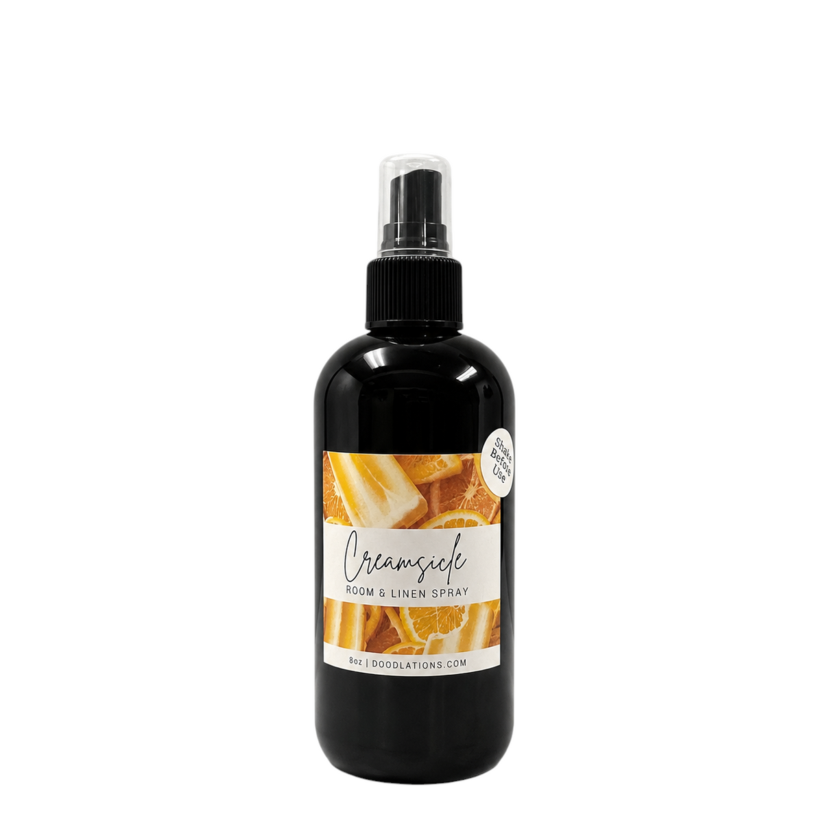 Doodlations Coffee Bar & Boutique Creamsicle room and linen spray in a black bottle with citrus fruit label design.