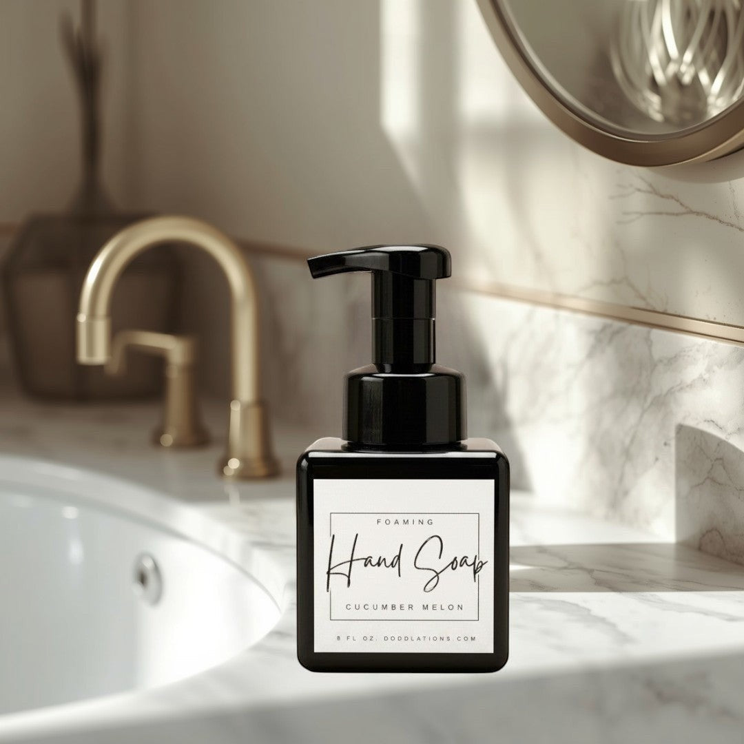Doodlations Coffee Bar & Boutique black foaming hand soap dispenser with Cucumber Melon scent label.