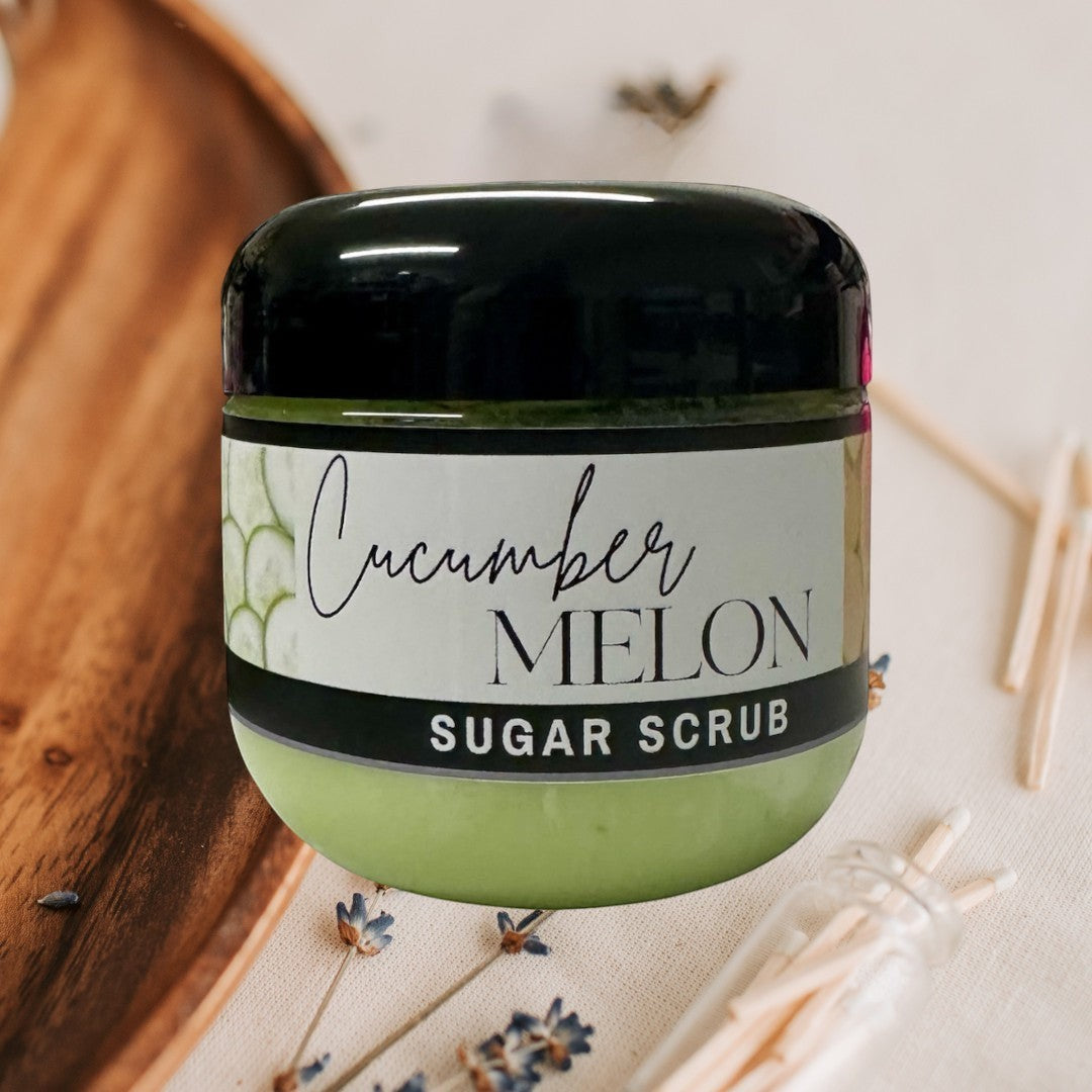 Doodlations Coffee Bar & Boutique Cucumber Melon Sugar Scrub, 4 oz jar, light green exfoliating body scrub with black lid.