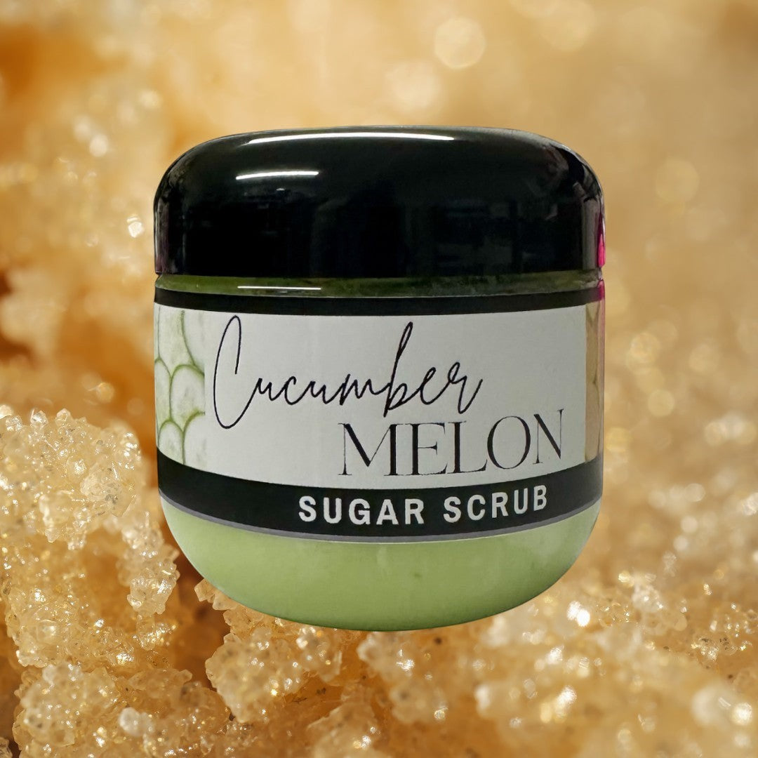 Doodlations Coffee Bar & Boutique Cucumber Melon Sugar Scrub, 4 oz jar, light green exfoliating body scrub with black lid.
