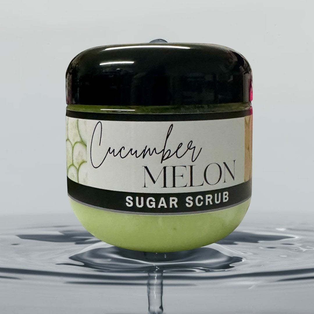 Doodlations Coffee Bar & Boutique Cucumber Melon Sugar Scrub, 4 oz jar with light green scrub and black lid, refreshing scent.