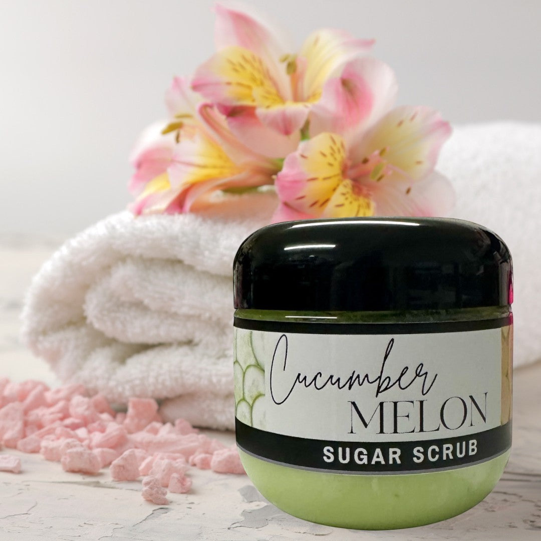 Doodlations Coffee Bar & Boutique Cucumber Melon Sugar Scrub, 4 oz jar, light green exfoliating body scrub with black lid.
