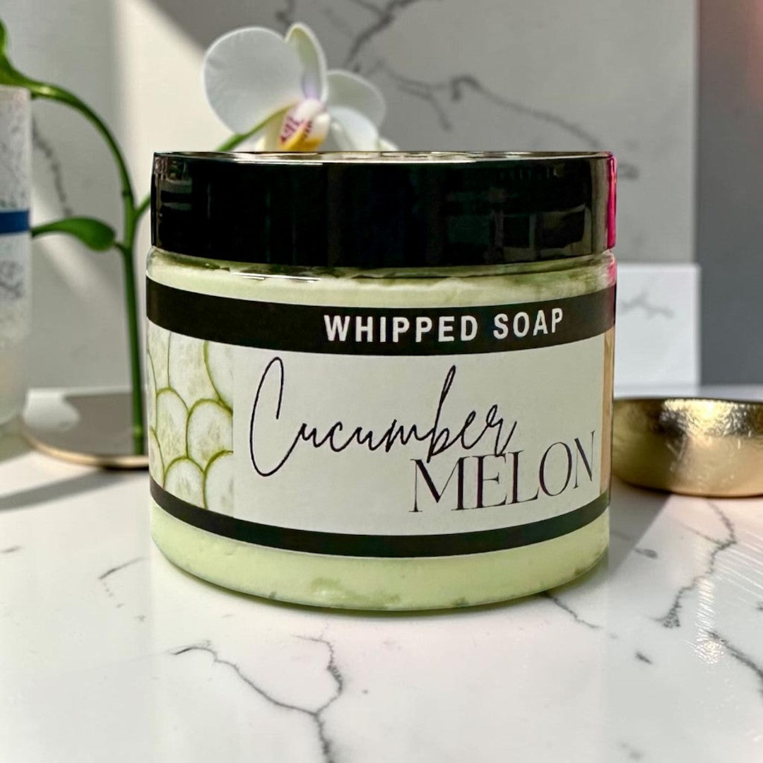Doodlations Coffee Bar & Boutique Cucumber Melon whipped soap in a 3.5oz jar with a black lid and light green cream.