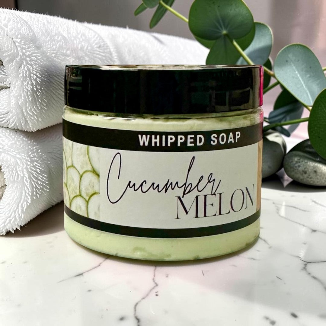 Doodlations Coffee Bar & Boutique Cucumber Melon whipped soap in a 3.5oz jar with a black lid and light green cream.