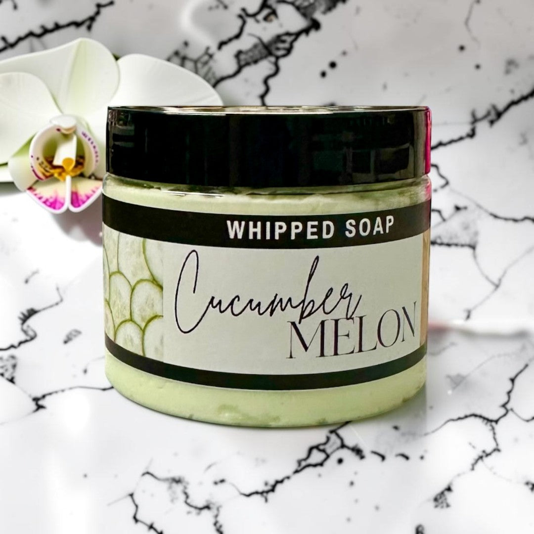 Doodlations Coffee Bar & Boutique Cucumber Melon whipped soap in a 3.5oz jar with a black lid and light green cream.